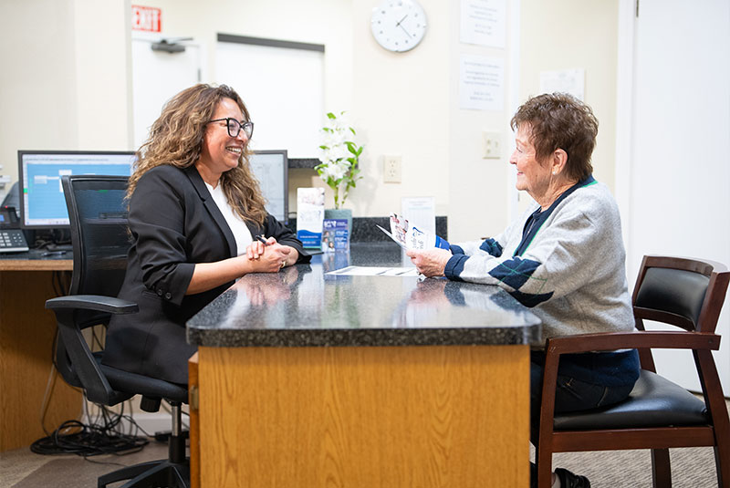 Team member and Patient going over insurance forms