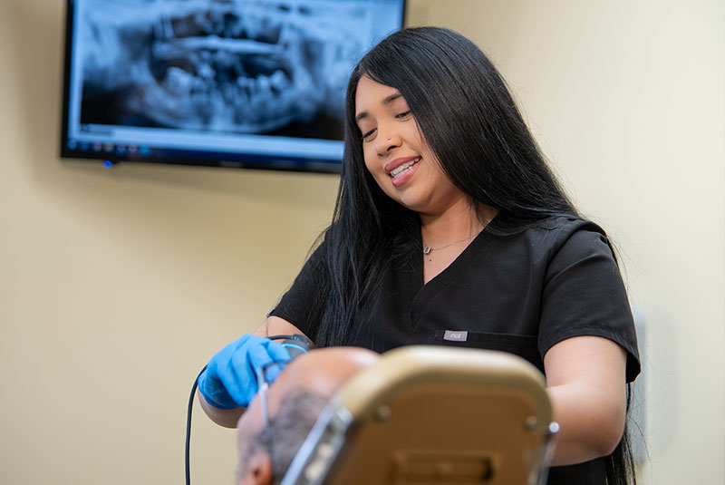 Team member taking a 3d scan of Patients mouth