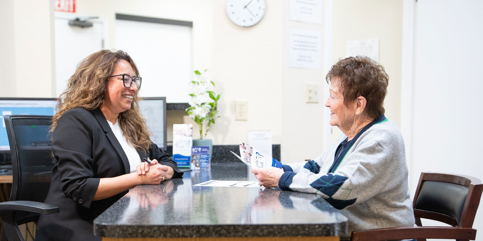 Staff member and patient talking about insurance and financing