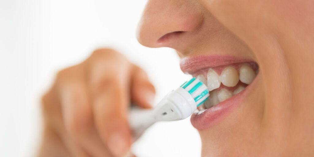 woman brushing her teeth