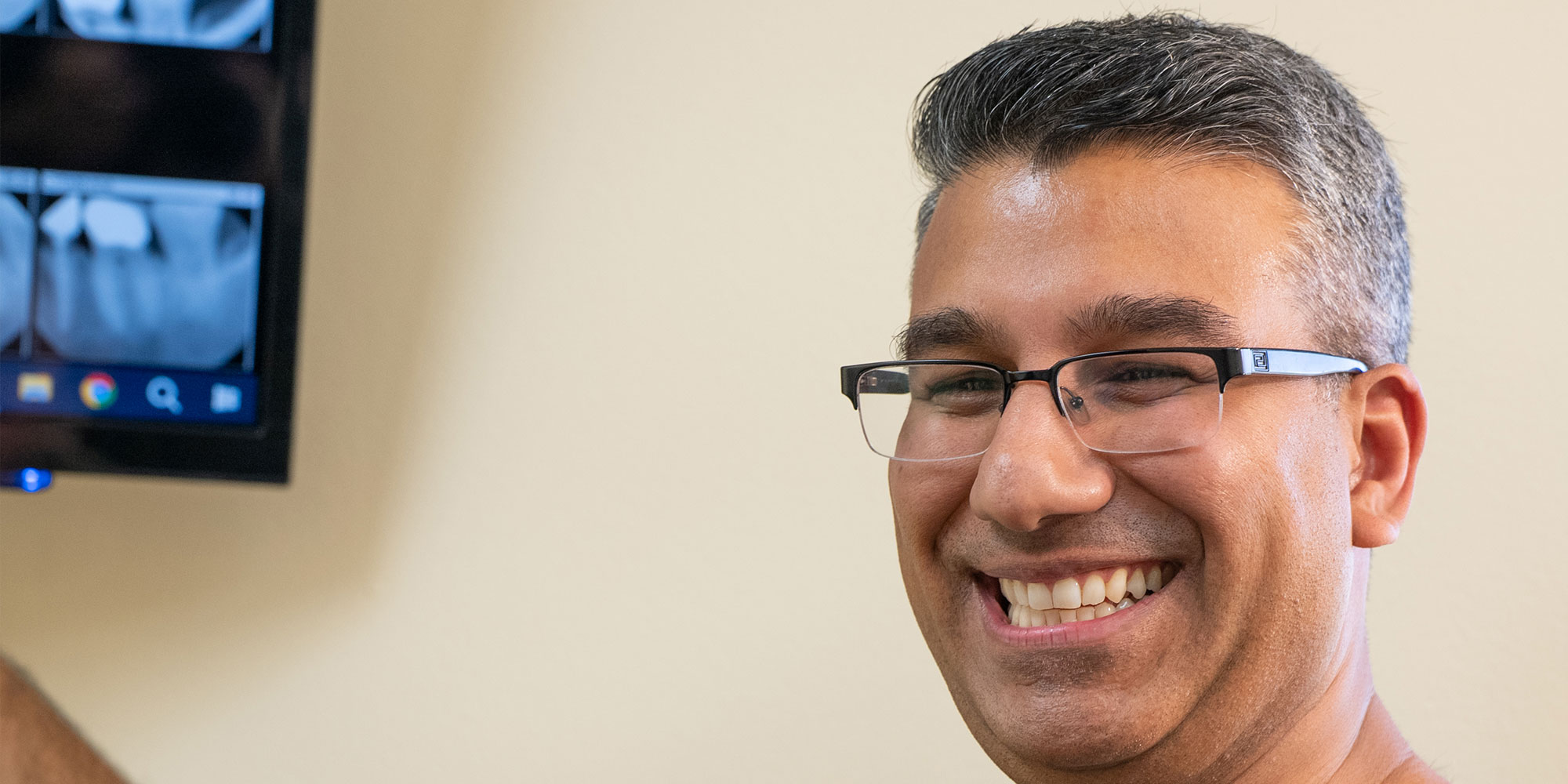 doctor Smiling at patient pointing at x-ray