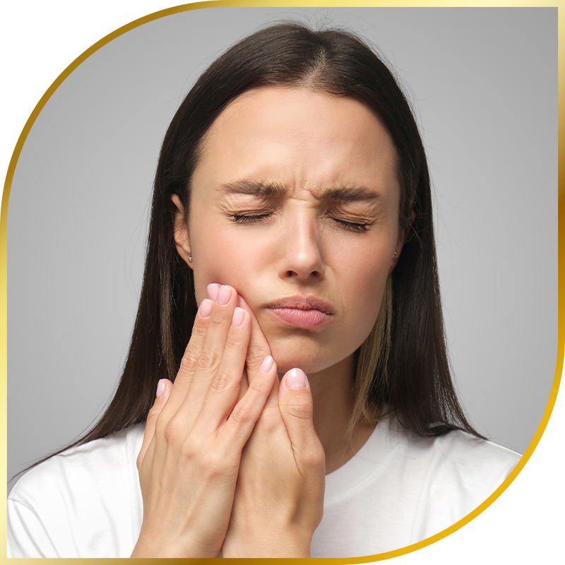 woman holding jaw in pain